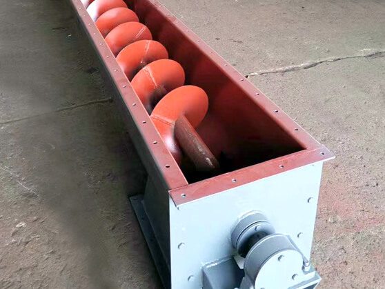 Screw-Conveyor--detail A large metal conveyor inside a factory, showing the detailed design of the screw conveyor mechanism.