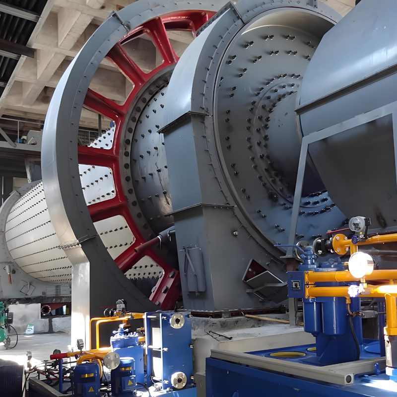cement-ball-mill-detail-1 An industrial cement ball mill within a factory, highlighting its significant size and essential role in the production process.