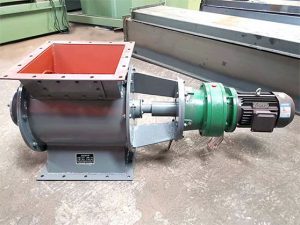 A large industrial rotary valve machine featuring a green cover, showcasing its robust metal construction and design.