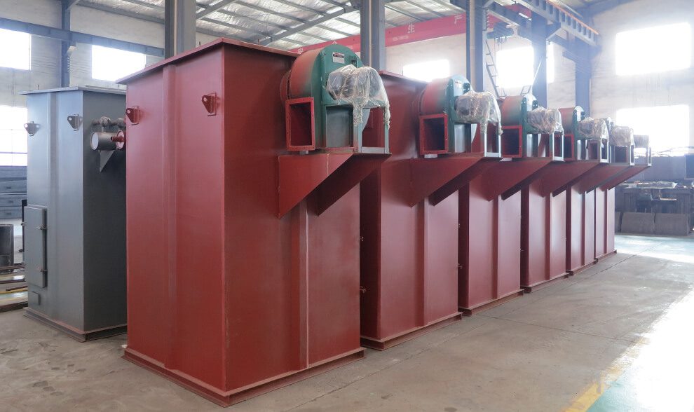 A row of vibrant red Uni-air filters lines the factory, highlighting their efficient design for air filtration in an industrial setting.