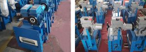 Several electric flow control valves are placed on the floor of the warehouse